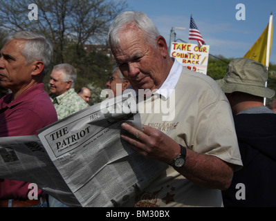 American Tea Party activist reads newspaper at a New York demonstration on Tax Day, April 15, 2010. © Katharine Andriotis Stock Photo