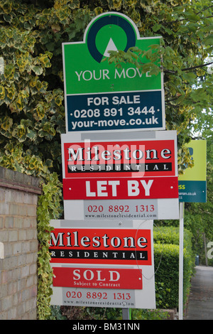 A mixture of 'For Sale', 'Let By' and 'Sold' estate agent signs on a London, UK street. May 2010 Stock Photo