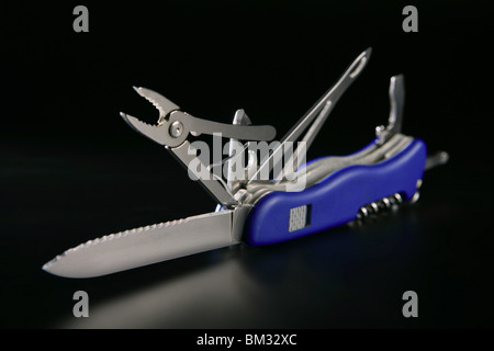 Swiss multi purpose blue knife isolated on black Stock Photo