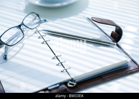 Diary, ballpoint pen and glasses Stock Photo