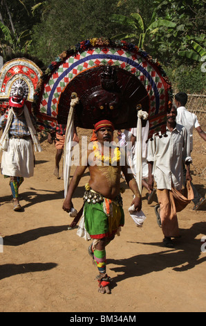 traditional poothan and thira dancers with colourful costumes from a festival in kerala,india Stock Photo