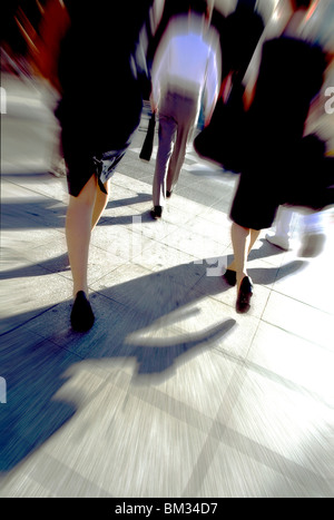 Business people walking down the street blurred motion Stock Photo