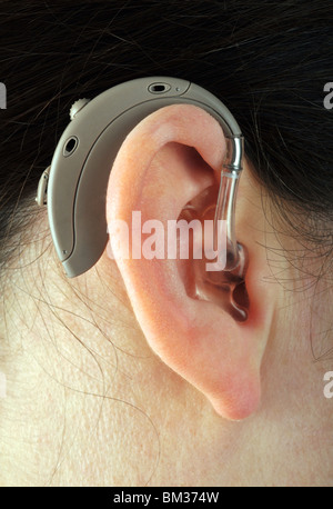 Digital hearing aid, hearing aid in a woman's ear Stock Photo