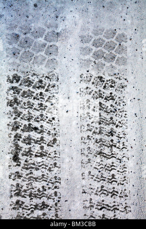 LORRY TIRE TRACKS IN SNOW: Lorry truck van tyre tire prints print tracks winter snow covered frozen road left tyre prints tyre tracks Stock Photo