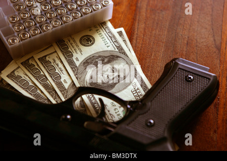 Dollar notes and gun, black pistol, mafia inspiration Stock Photo