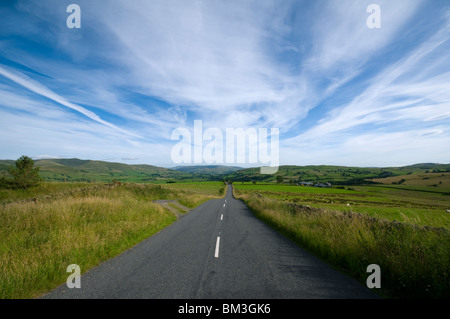 Cirrus cloud over the B6261 road, Crosby Ravensworth Fell near Tebay, Cumbria, England, UK Stock Photo