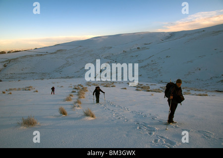 Walkers heading up Brae Fell in the Caldbeck Fells in winter, Lake District, Cumbria, England, UK Stock Photo