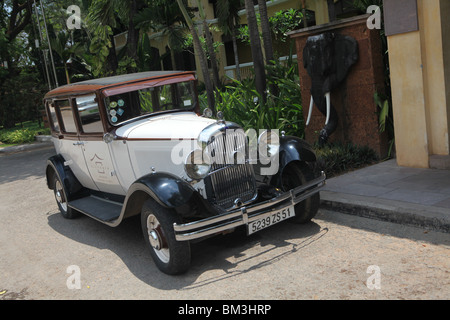 A classic car parked outside the Victoria Angkor Hotel in Siem Reap, Cambodia. Stock Photo