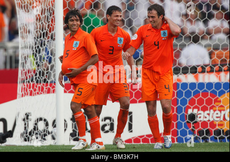 Giovanni Van Bronckhorst (5) hides the ball under his shirt as he celebrates a victory over Cote d'ivoire at the 2006 World Cup. Stock Photo