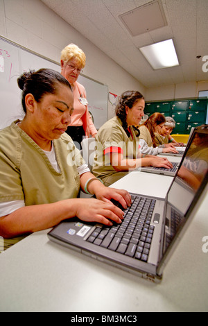 Multi-ethnic inmate computer class at the City Jail Womens Unit in Santa Ana, California. Note jail uniforms. Stock Photo
