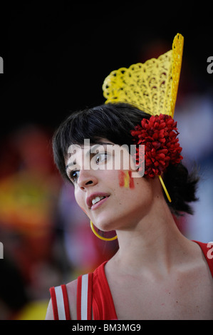 Young lady from Spain, she is a football fan of his national team. She is dressed in yellow and red, the colors of the Spain Stock Photo