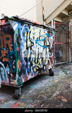 Graffiti on dumpster in back alley in downtown Olympia, Washington. Stock Photo
