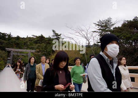 Tourists walking over a wooden bridge to the Ise Grand Shrine, Ise, Japan Stock Photo