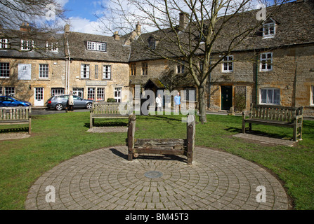 Old stocks in a quiet corner of Stow-on-the-Wold at springtime, Stow is a popular Cotswold market town on the Fosse Way Stock Photo