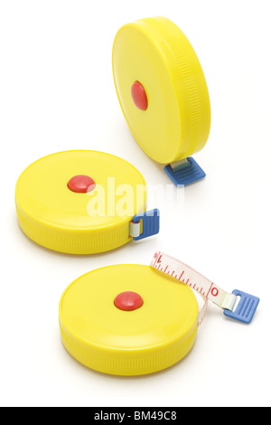Three yellow plastic measuring tapes on white background Stock Photo