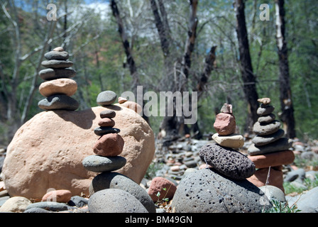 Pebbles arranged as standing stone sculptures at Oak Creek River in Red Rock State Park just outside Sedona Arizona USA Stock Photo