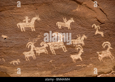 Petroglyph on rock featuring shepherds or hunters on horseback with sheep or goats, Arches National Park, Utah, USA