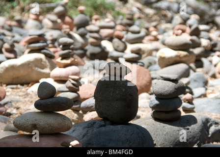Pebbles arranged as standing stone sculptures at Oak Creek River in Red Rock State Park just outside Sedona Arizona USA Stock Photo