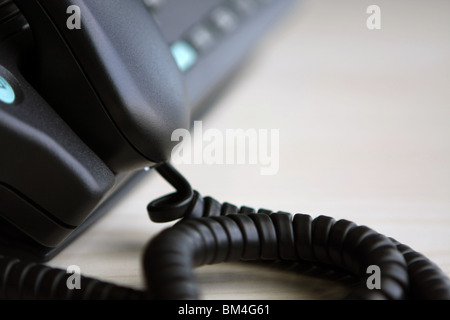 part of a telephone with the receiver off the hook Stock Photo