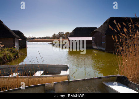 View of Hickling Broad Norfolk with thatched boat houses Stock Photo