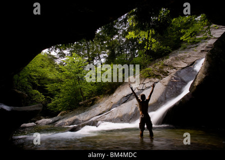 A man enjoys a pool of water at the base of Hamilton Falls in Vermont's Jamaica State Park.  Green Mountains.  Cobb Brook
