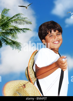 Portrait of a young beautiful happy boy over blue sky Stock Photo