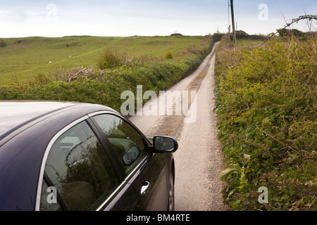 UK, England, Devon, Ilfracombe, Higher Hawcombe, car driving along narrow country lane Stock Photo