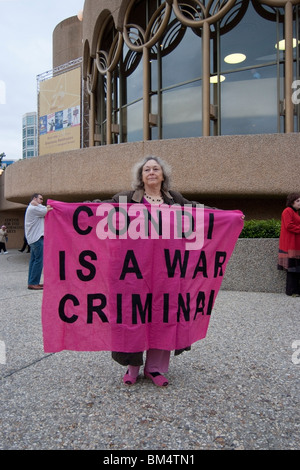 Woman from CODEPINK with a sign outside the auditorium before former Secretary of State, Condoleezza Rice speaks in San Jose Stock Photo