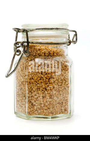 A container filled with sesame seeds on a white background Stock Photo