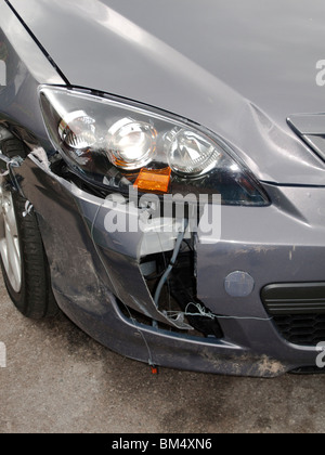 Broken in a crash, a car's brittle plastic bumper cover shows the vehicle's vulnerability to collision damage. Stock Photo