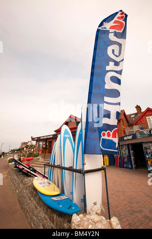 UK, England, Devon, Woolacombe, tourist economy, banner flying over Surf Shop surfboards Stock Photo