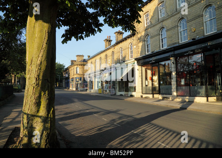 Shops on Victoria Road, in Saltaire, a UNESCO World Heritage Site in Bradford, West Yorkshire Stock Photo