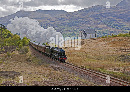 Black Five steam engine No. 45231 pulls the first Jacobite of the season past the famous church at Polnish en route to Mallaig Stock Photo