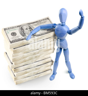 wooden man standing over bundles of U.S. dollars Stock Photo