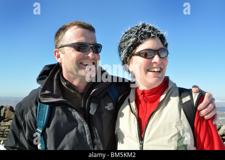 A married couple keep fit by walking on a bright sunny winter day. Stock Photo