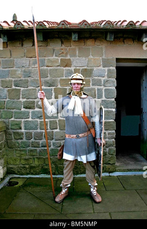 Roman costume dressed soldier on guard position with spear and shield helmet and armor colour Stock Photo