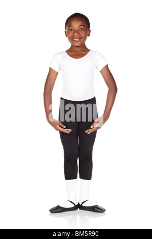 Young African ballet boy on white background and reflective white floor showing various ballet steps and positions. Not Isolated Stock Photo