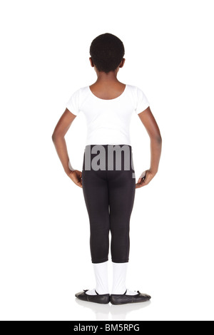 Young African ballet boy on white background and reflective white floor showing various ballet steps and positions. Not Isolated Stock Photo