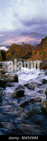 Ashness Bridge near Keswick in the Lake District National Park, Cumbria, England. Dewent Water and Skiddaw can be seen in the distance. Stock Photo