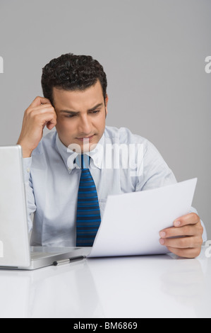 Businessman reading a document Stock Photo