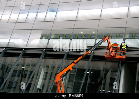 Construction workers on a crane in London Stock Photo