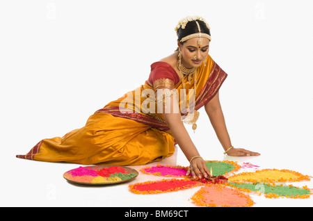 South Indian woman making rangoli Stock Photo