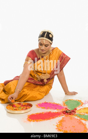 South Indian woman making rangoli Stock Photo