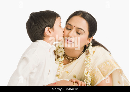 Boy kissing his mother Stock Photo