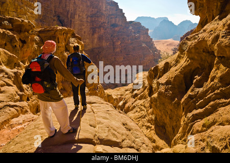 Bedouin guide and visitor in Rakabat canyon, Wadi Rum Protected Area, Jordan Stock Photo