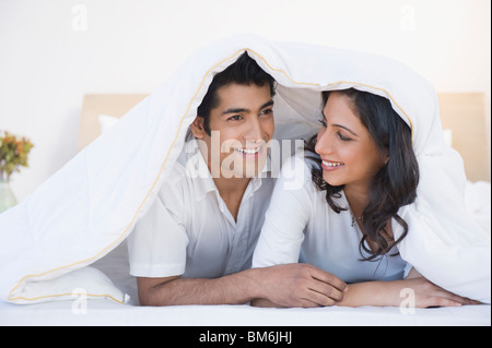 Couple lying on the bed and smiling Stock Photo