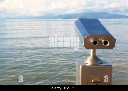 A metallic coin operated viewer for tourists to look at the Greek Islands Stock Photo