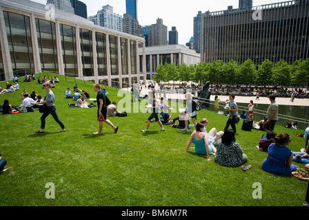 Visitors enjoy the new 'Illuminated Lawn' feature in the north plaza of Lincoln Center for the performing Arts in New York Stock Photo