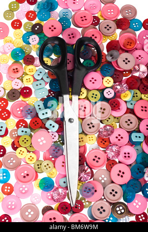 Scissors on a heap of buttons Stock Photo