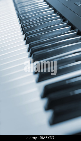 Keys of the piano. A photo close up. Blue tone. Stock Photo